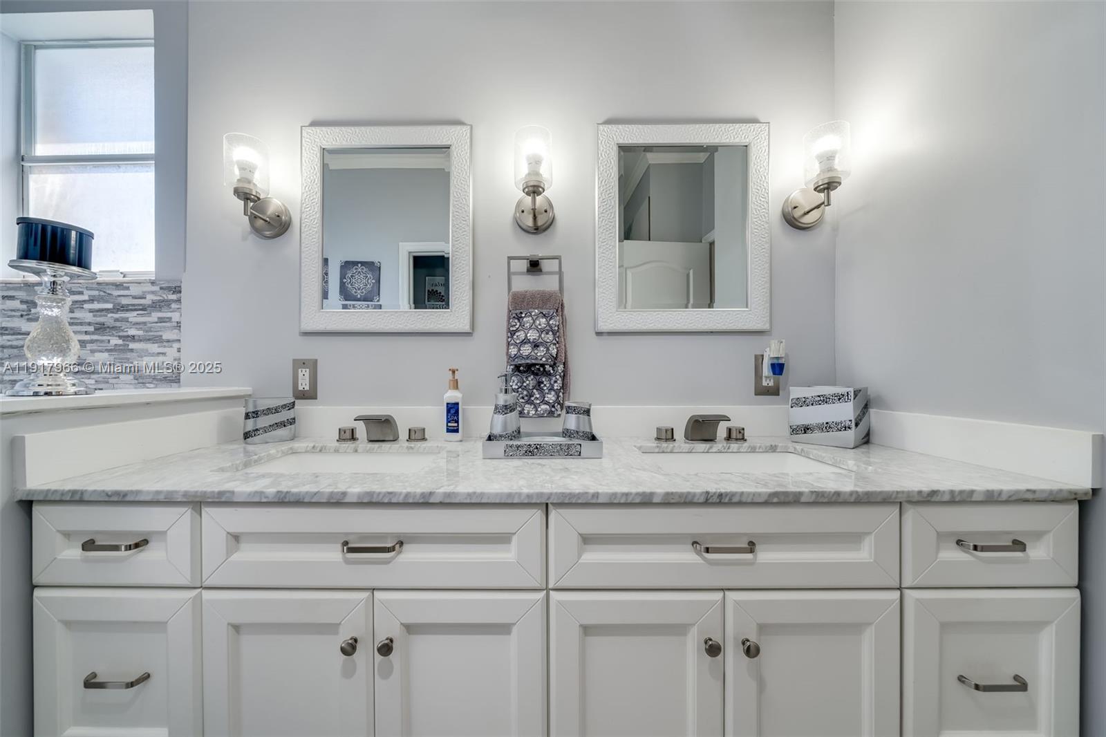 15242 Southwest 8th Way Miami, FL 33194 - Photo 28 of 62 a bathroom with a sink and a mirror