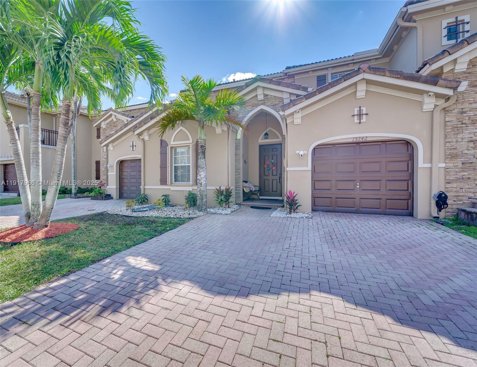 15242 Southwest 8th Way Miami, FL 33194 - Photo 3 of 62 a front view of a house with a yard and garage