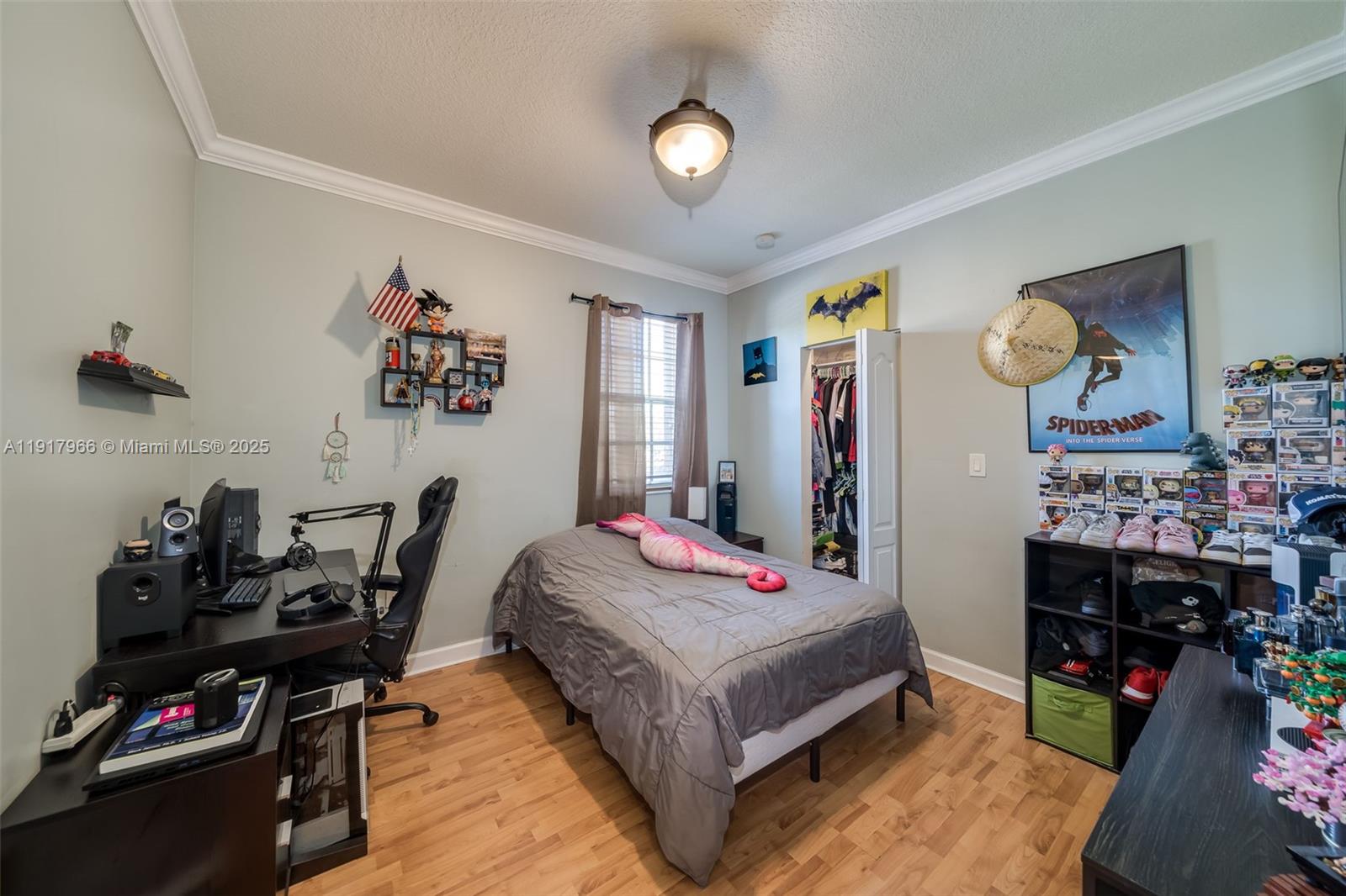 15242 Southwest 8th Way Miami, FL 33194 - Photo 32 of 62 a bedroom with bed and a chandelier