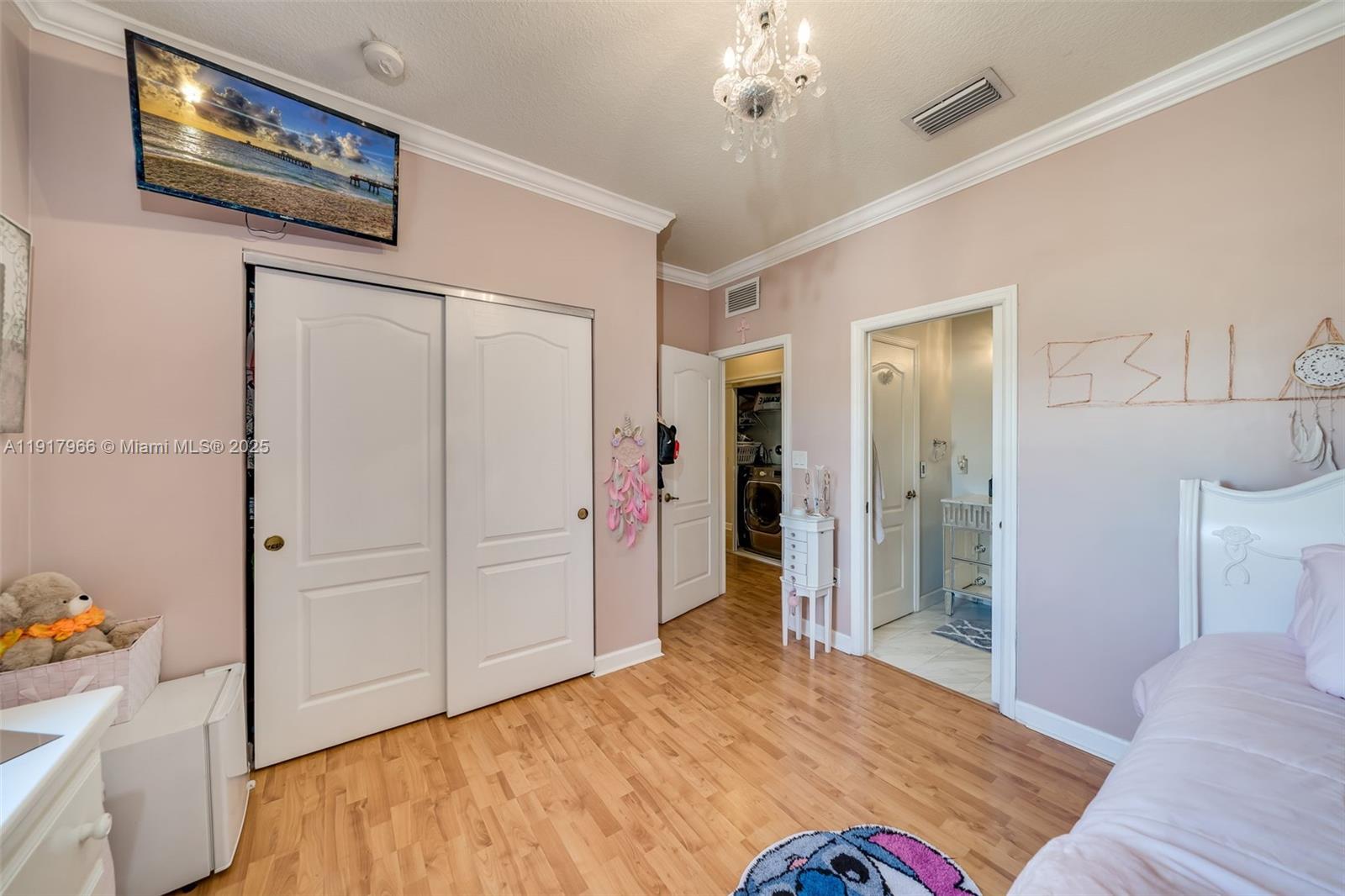 15242 Southwest 8th Way Miami, FL 33194 - Photo 34 of 62 a bedroom with a bed and a chandelier