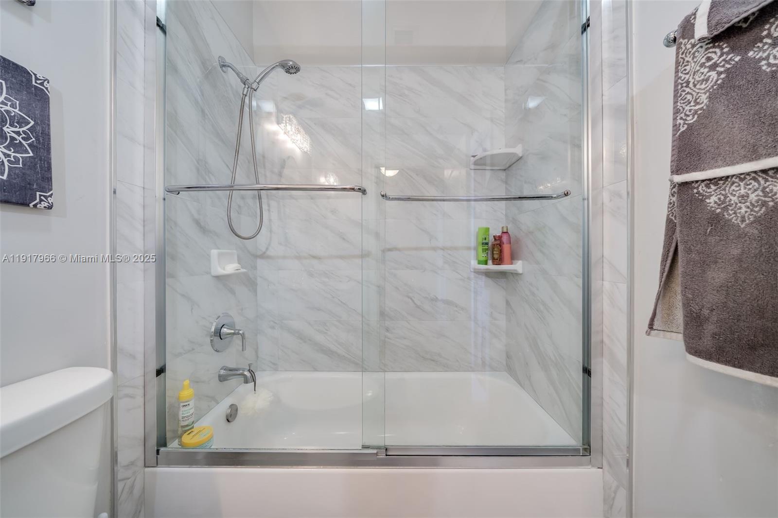 15242 Southwest 8th Way Miami, FL 33194 - Photo 36 of 62 a bathroom with a bath tub and a shower