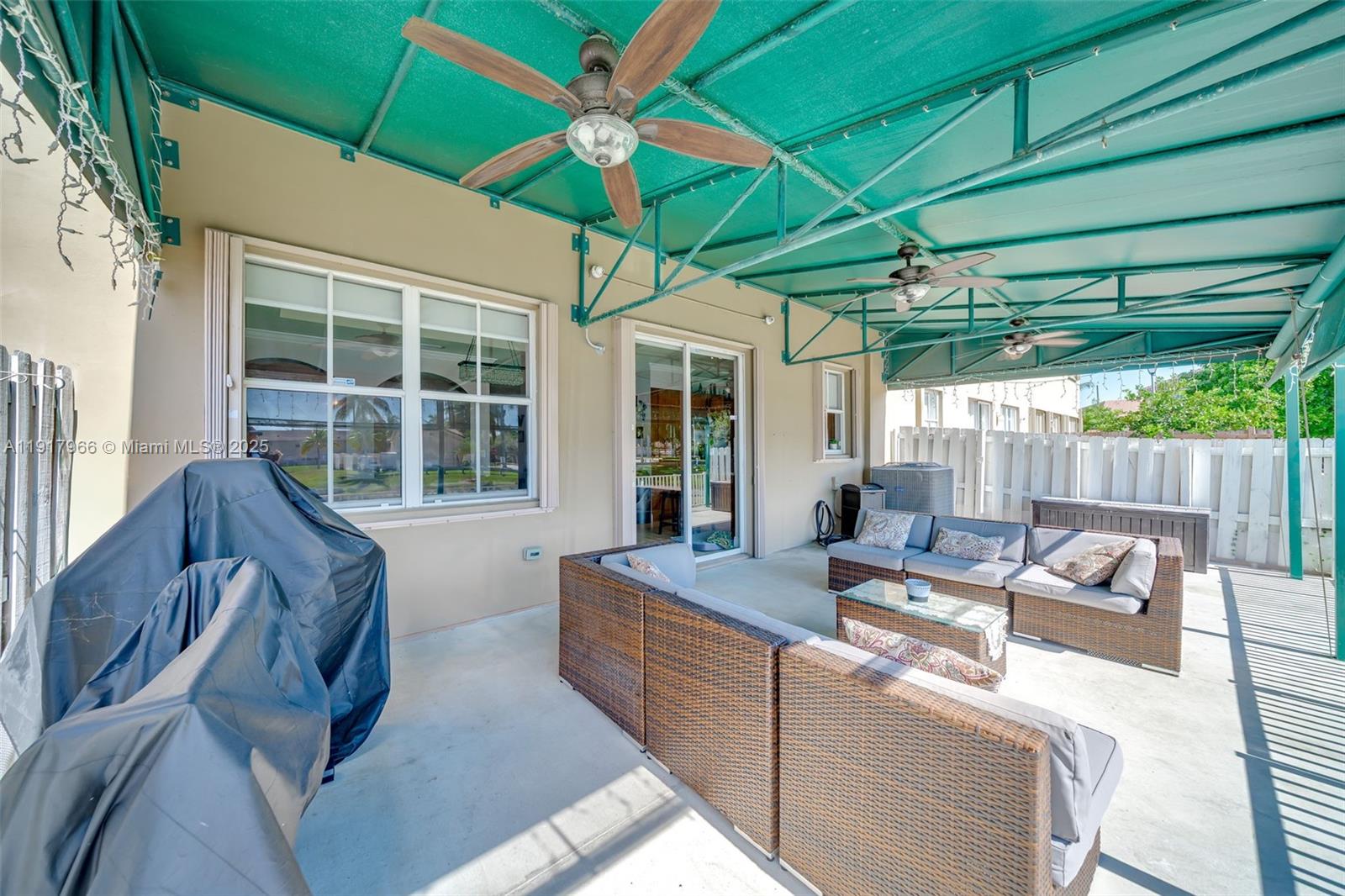15242 Southwest 8th Way Miami, FL 33194 - Photo 40 of 62 a outdoor living space with furniture and umbrella