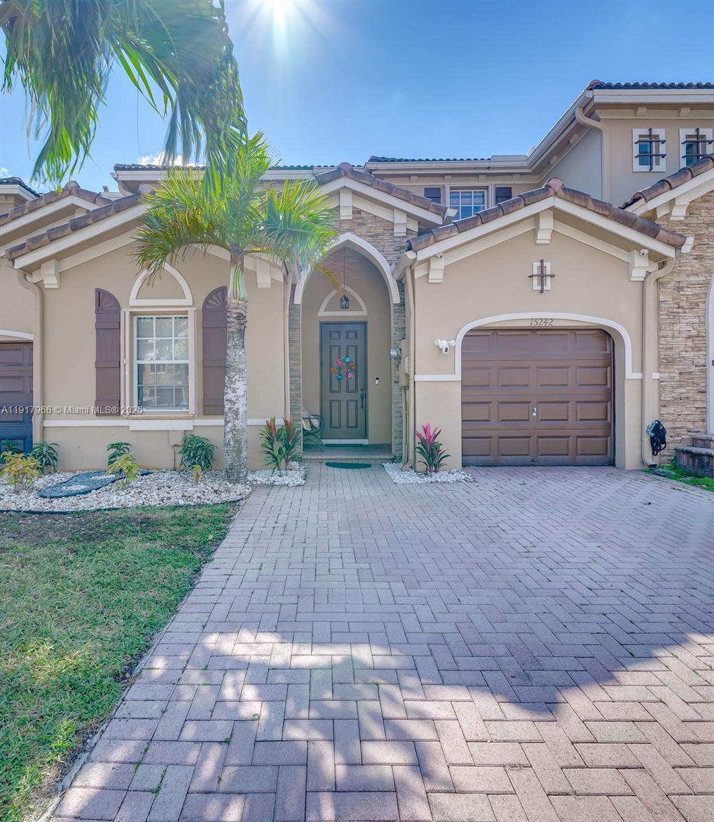 15242 Southwest 8th Way Miami, FL 33194 - Photo 4 of 62 a front view of a house with a yard and garage