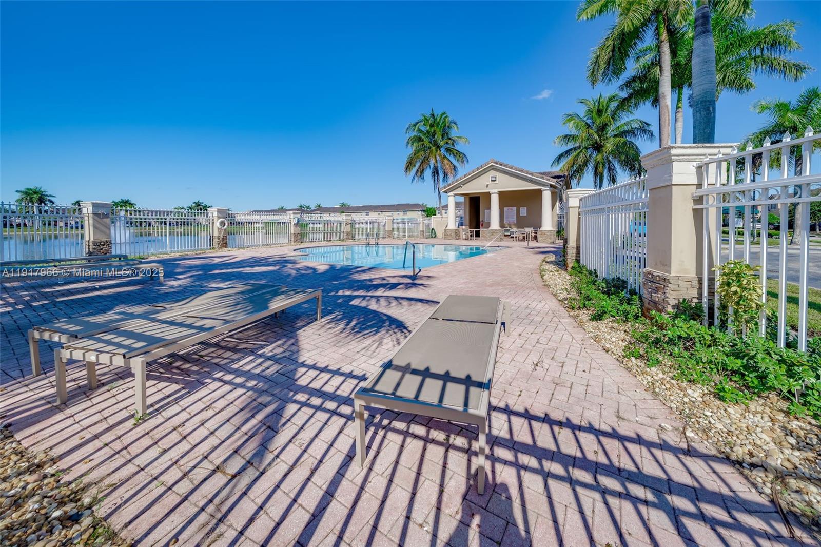 15242 Southwest 8th Way Miami, FL 33194 - Photo 53 of 62 a balcony with wooden floor table and chairs