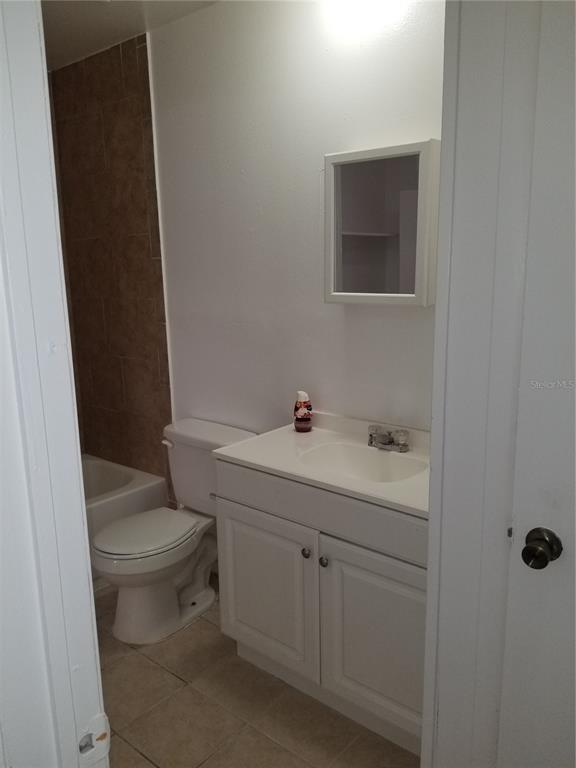 1306 East 137th Avenue, Unit C Tampa, FL 33613 - Photo 5 of 10 a bathroom with a sink a toilet and shower