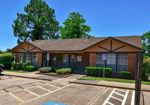 a view of a big yard in front of a brick house