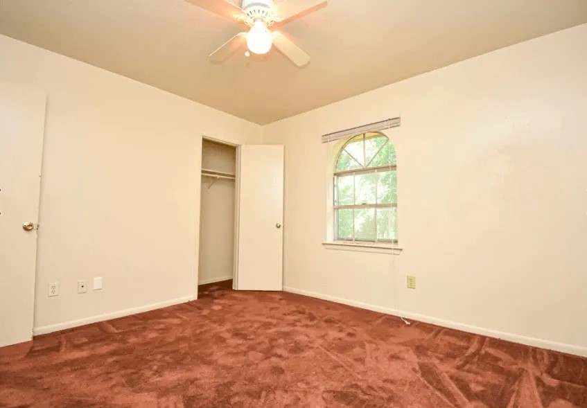 20598 Pine Island Road Hempstead, TX 77445 - Photo 8 of 8 an empty room with windows and fan