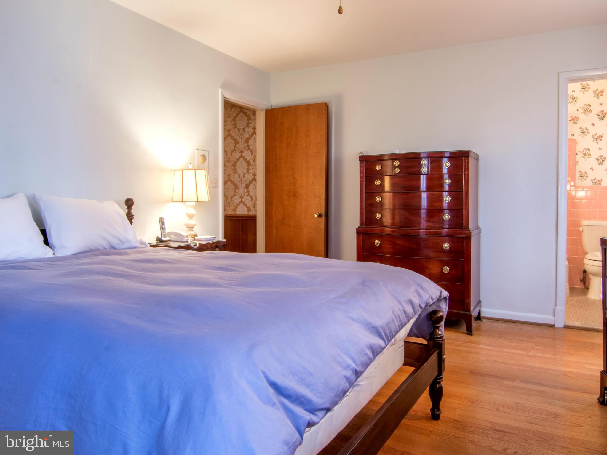 801 Huntsman Road Baltimore, MD 21286 - Photo 12 of 22 a bedroom with a bed and wooden floor