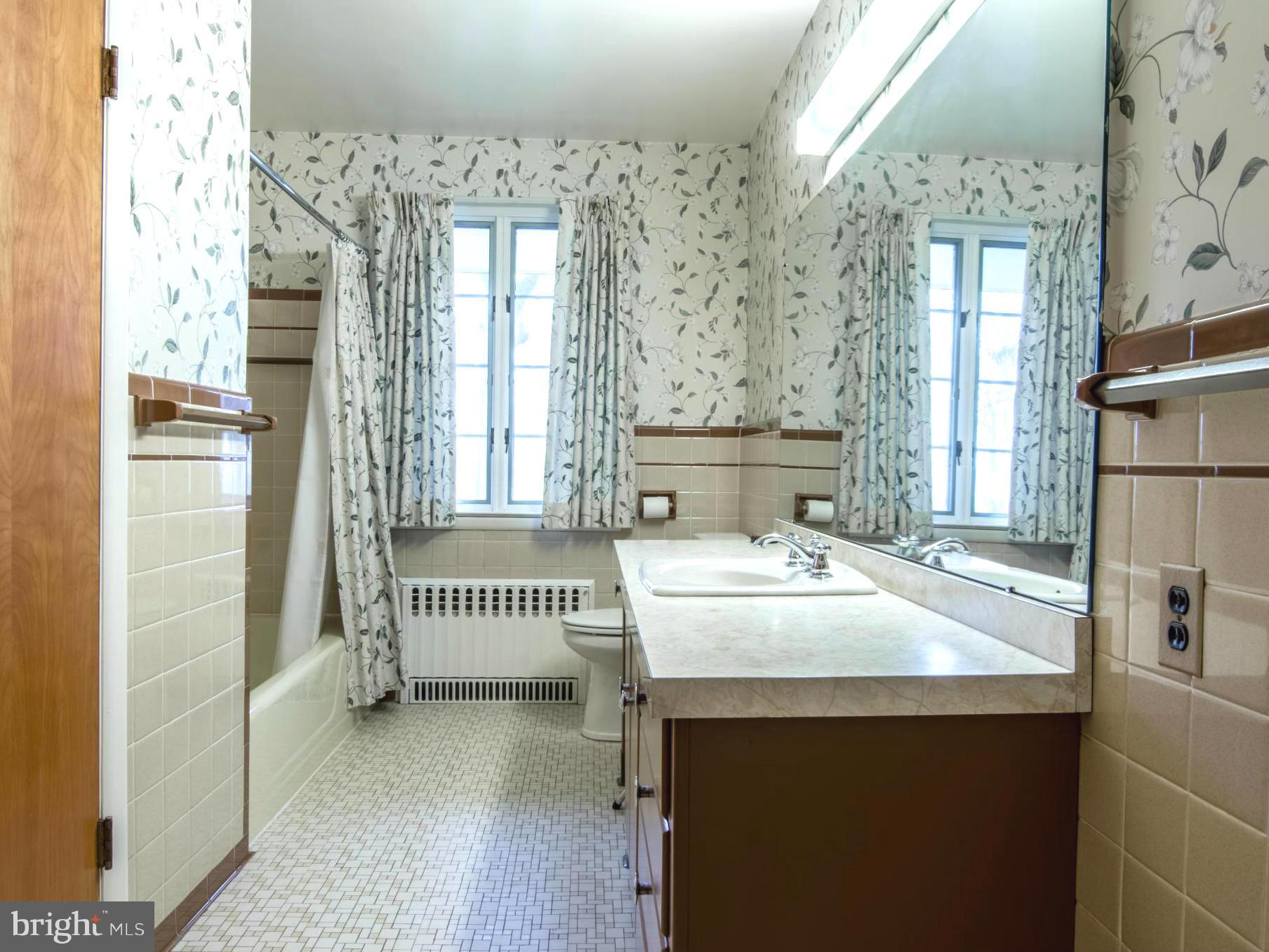 801 Huntsman Road Baltimore, MD 21286 - Photo 16 of 22 a spacious bathroom with a sink and a mirror