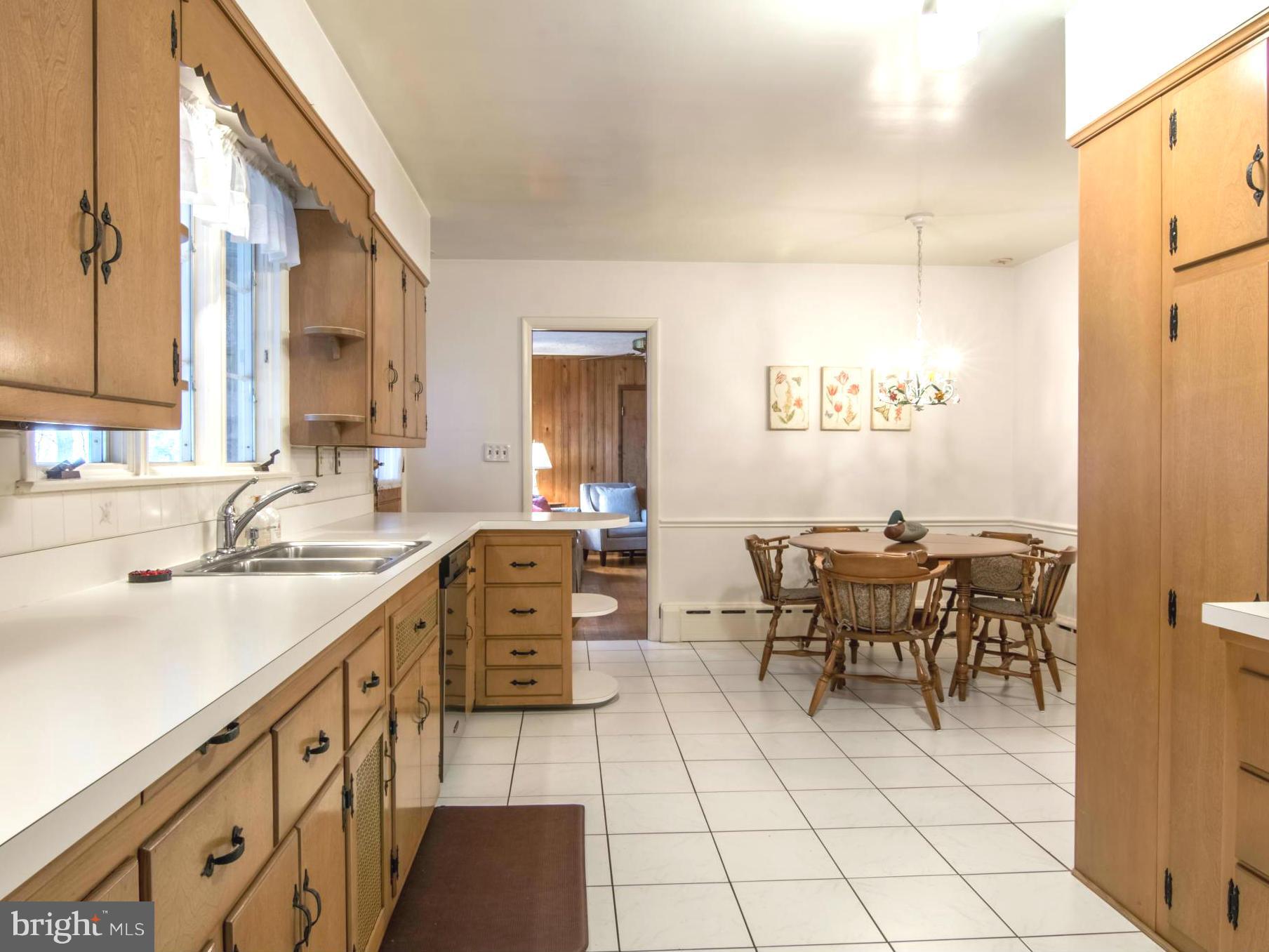 801 Huntsman Road Baltimore, MD 21286 - Photo 9 of 22 a kitchen with stainless steel appliances a sink stove and table
