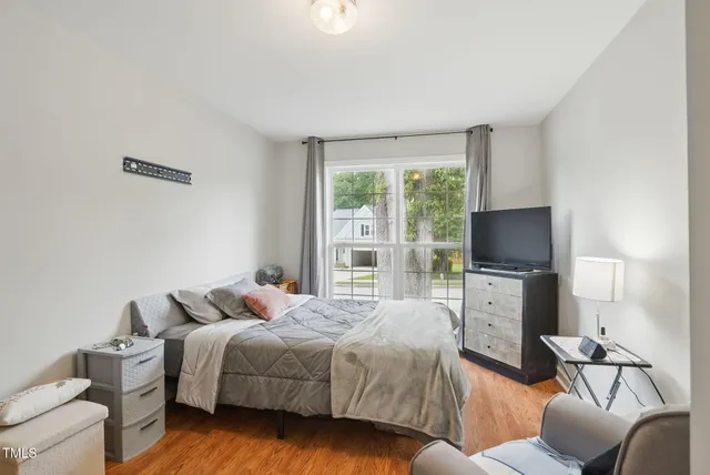a bedroom with a bed and a flat screen tv