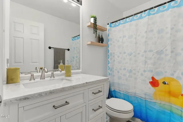 a bathroom with a granite countertop sink a toilet and a bathtub
