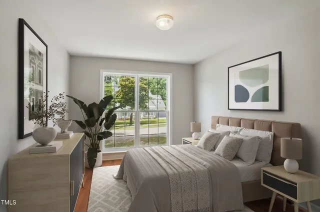 a bedroom with furniture and a potted plant