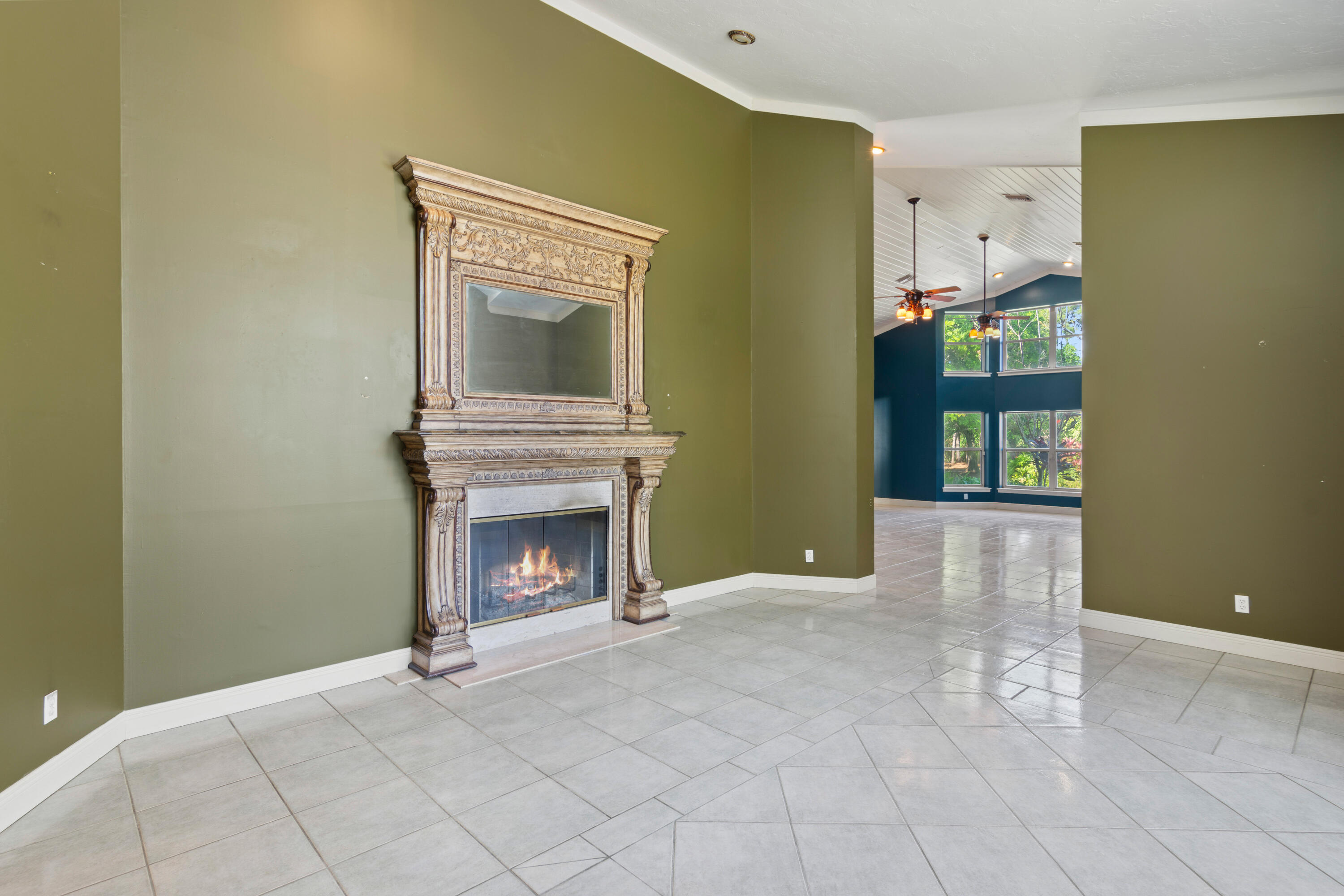 8850 Hidden Pines Road Fort Pierce, FL 34945 - Photo 11 of 72 a view of an empty room with fireplace and a window