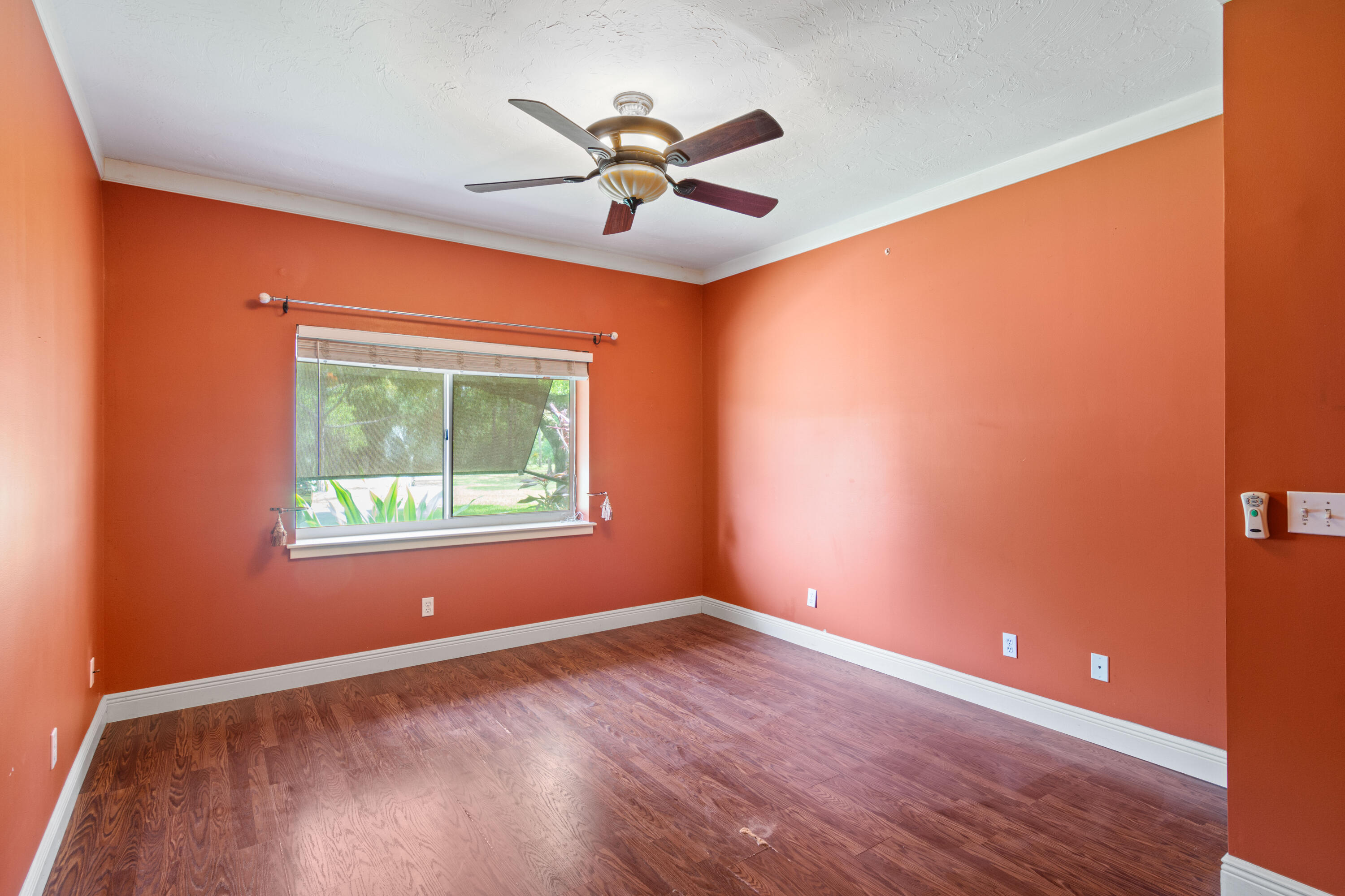 8850 Hidden Pines Road Fort Pierce, FL 34945 - Photo 16 of 72 an empty room with a window and a ceiling fan