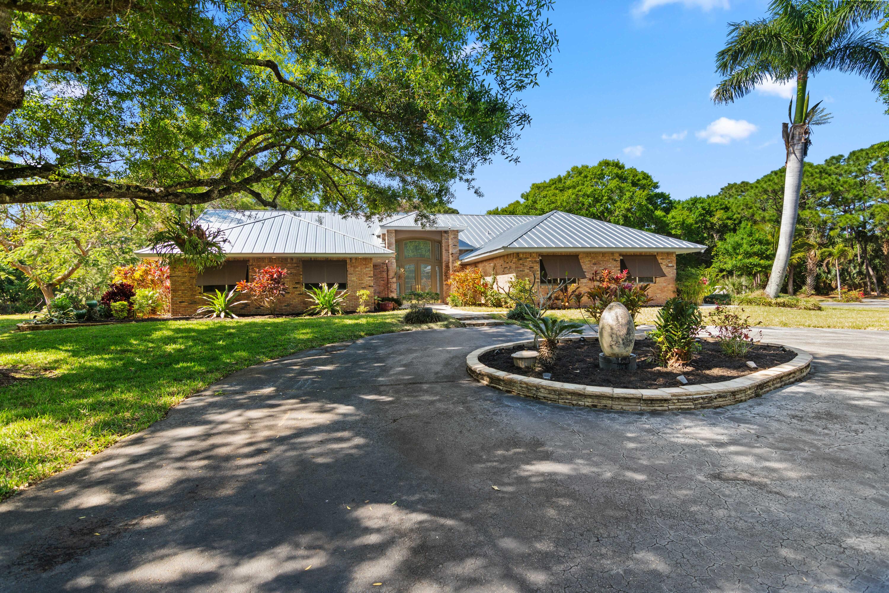8850 Hidden Pines Road Fort Pierce, FL 34945 - Photo 2 of 72 a swimming pool with outdoor seating and yard
