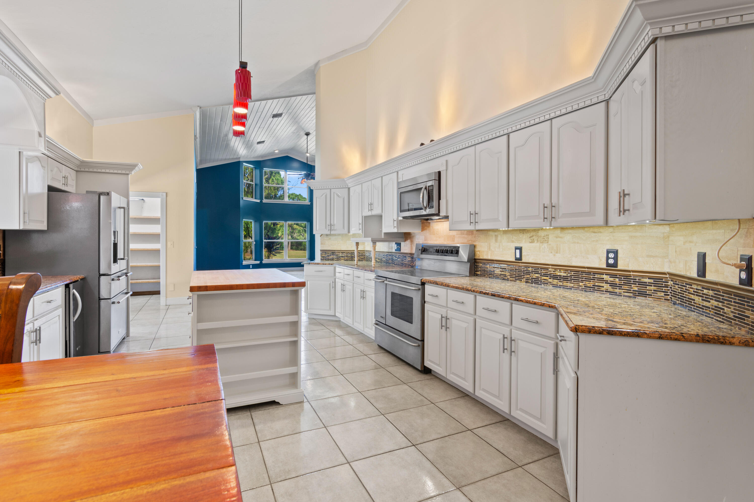 8850 Hidden Pines Road Fort Pierce, FL 34945 - Photo 23 of 72 a kitchen with granite countertop a sink and cabinets