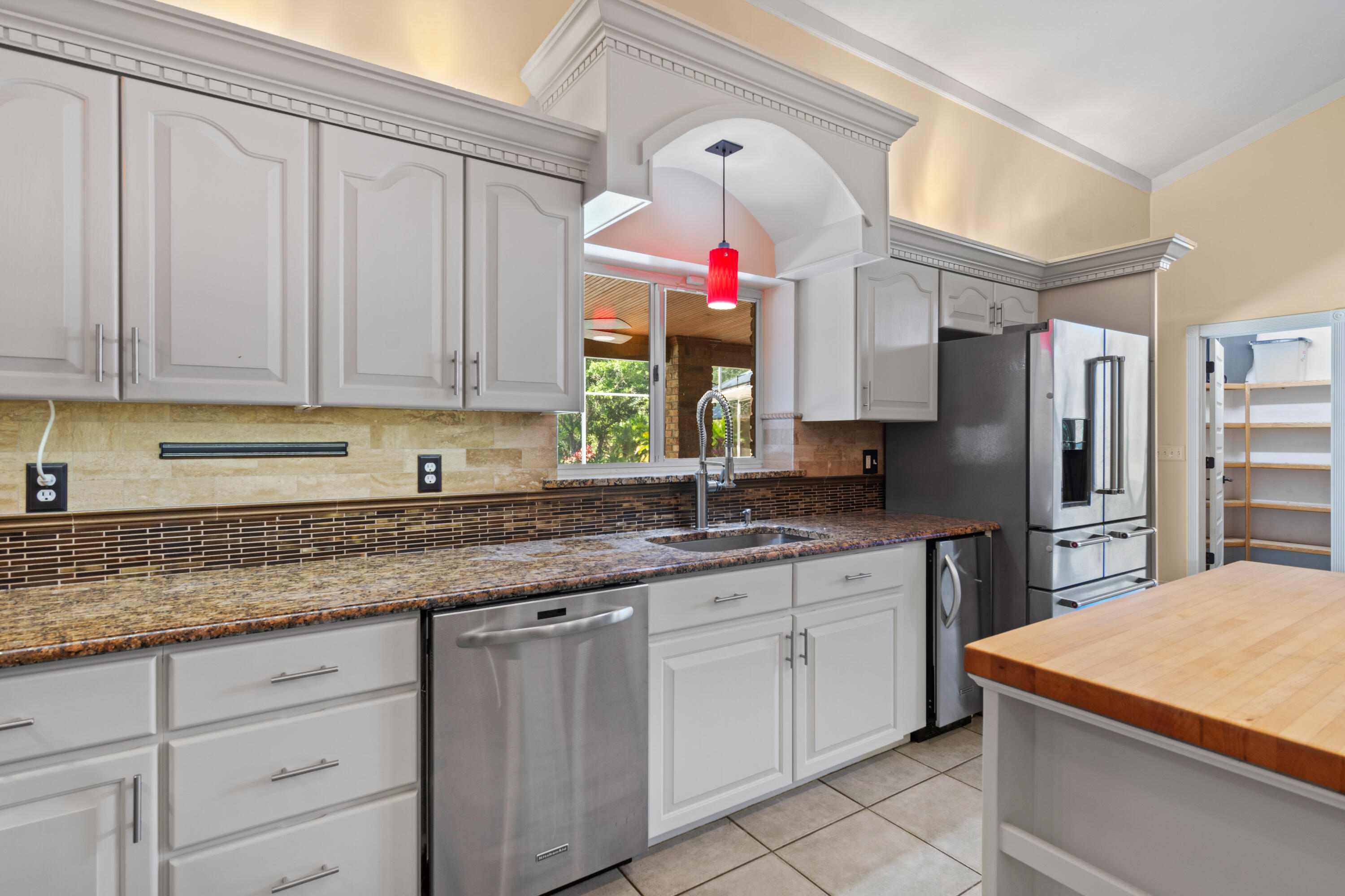 8850 Hidden Pines Road Fort Pierce, FL 34945 - Photo 24 of 72 a kitchen with granite countertop a sink stainless steel appliances and cabinets