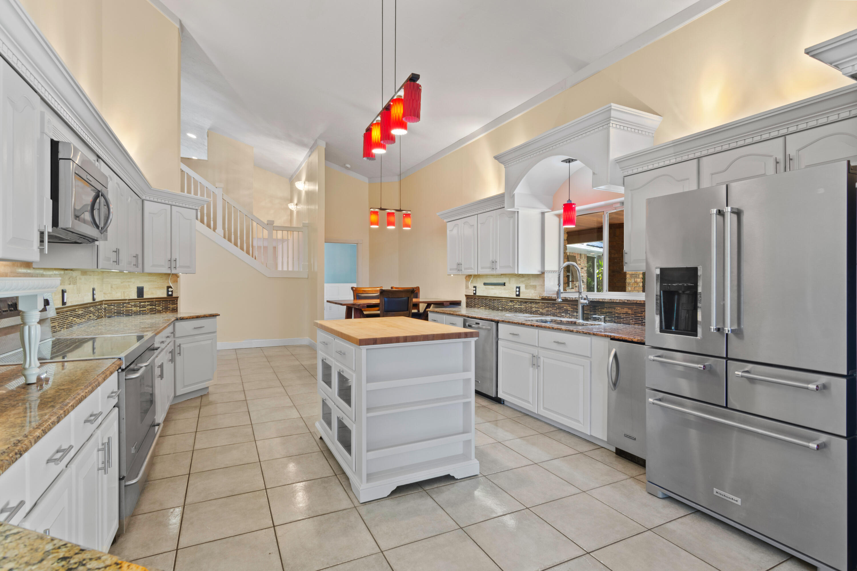 8850 Hidden Pines Road Fort Pierce, FL 34945 - Photo 26 of 72 a kitchen with a sink cabinets and stainless steel appliances