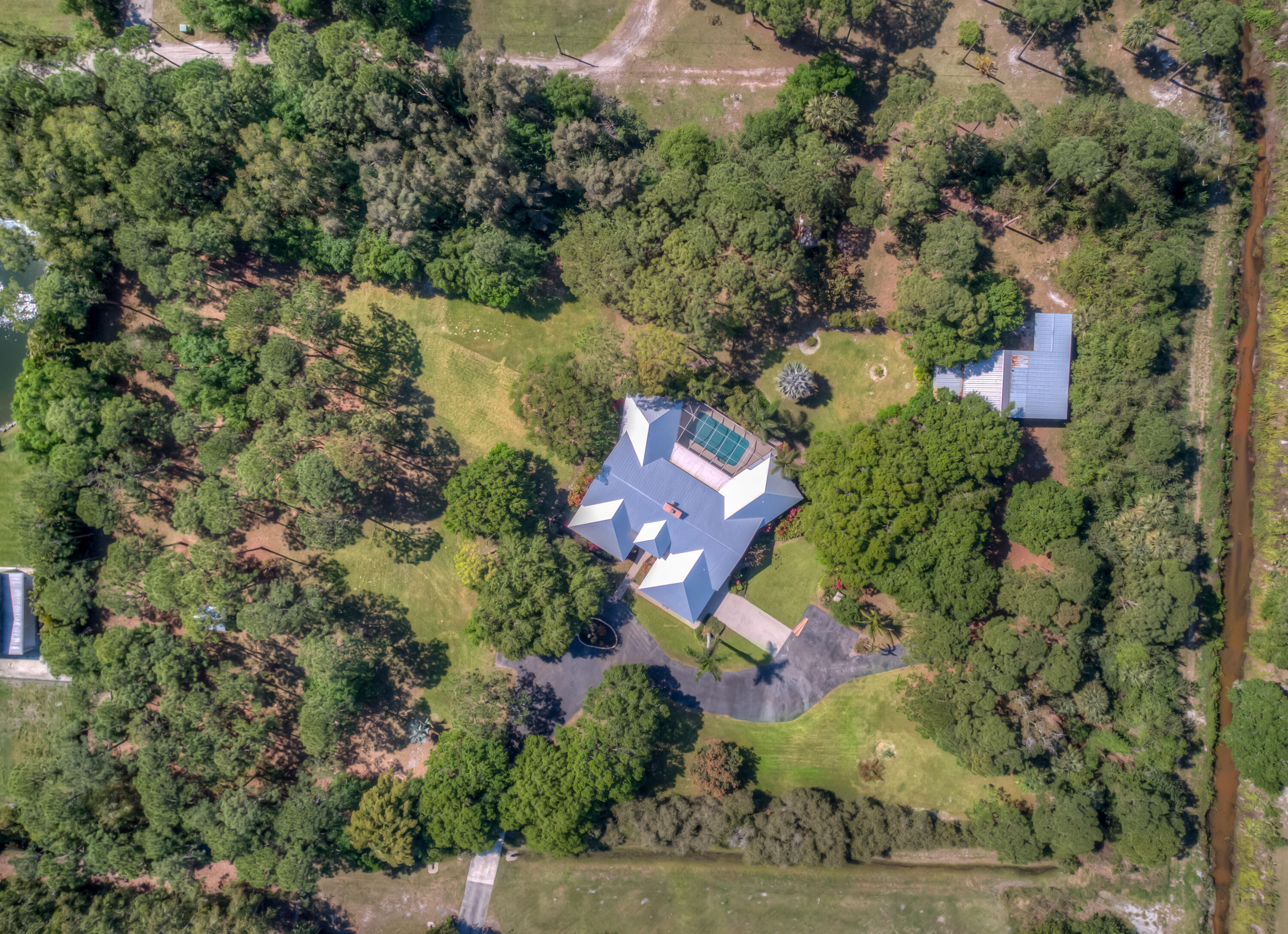 8850 Hidden Pines Road Fort Pierce, FL 34945 - Photo 3 of 72 an aerial view of a house with a yard