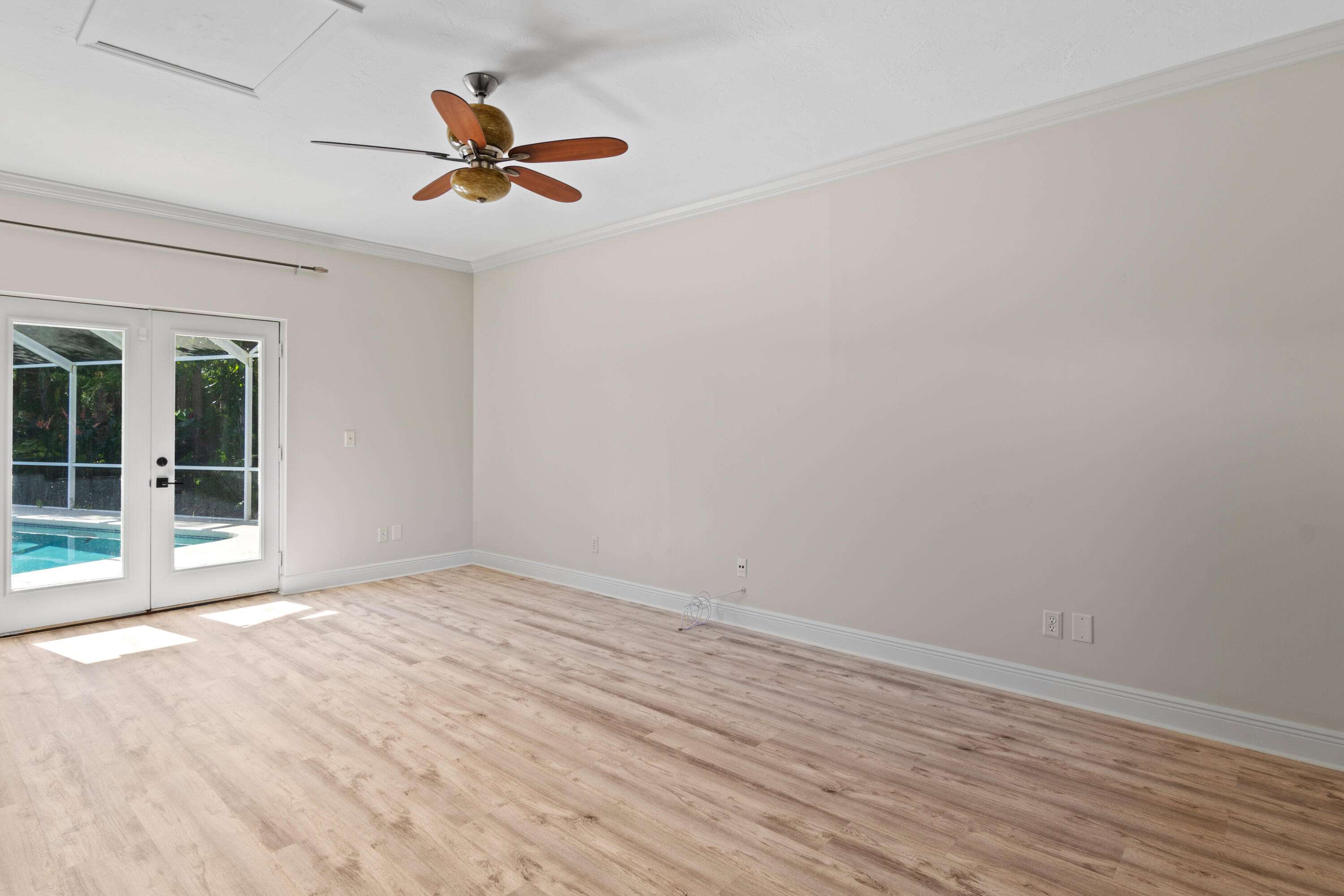 8850 Hidden Pines Road Fort Pierce, FL 34945 - Photo 34 of 72 an empty room with a ceiling fan and wooden floor