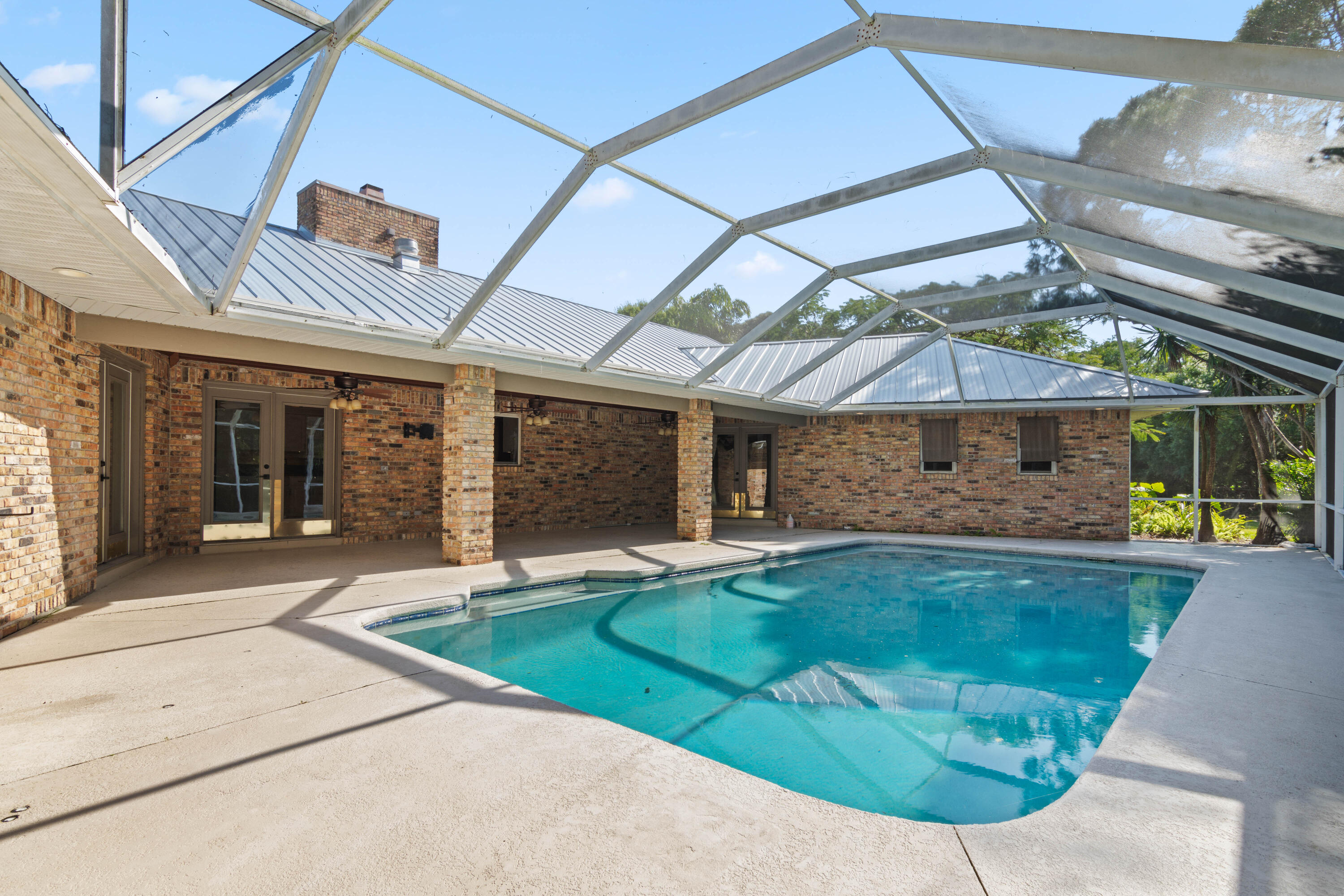 8850 Hidden Pines Road Fort Pierce, FL 34945 - Photo 48 of 72 a view of a house with backyard and sitting area
