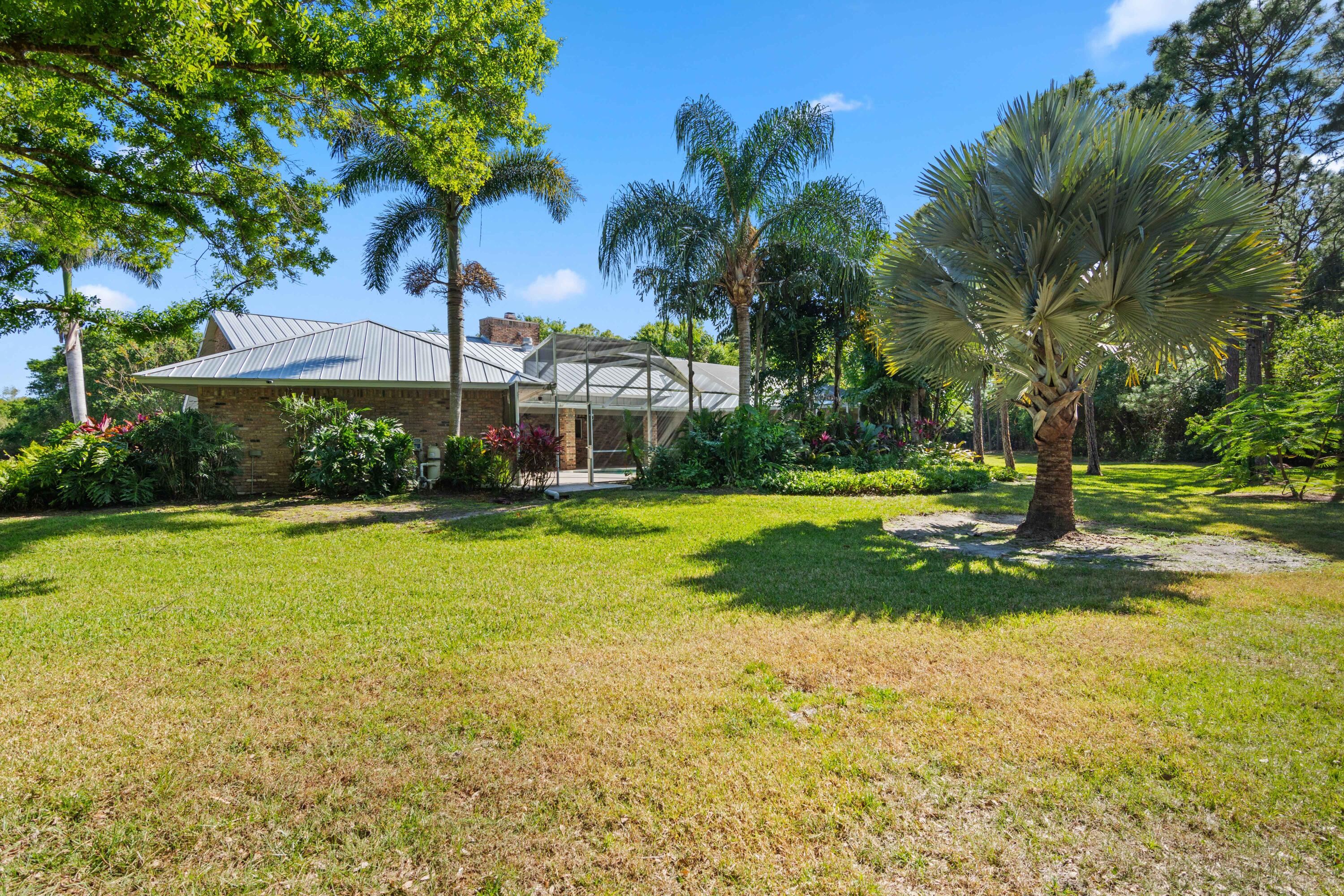 8850 Hidden Pines Road Fort Pierce, FL 34945 - Photo 49 of 72 a view of a house with swimming pool and yard