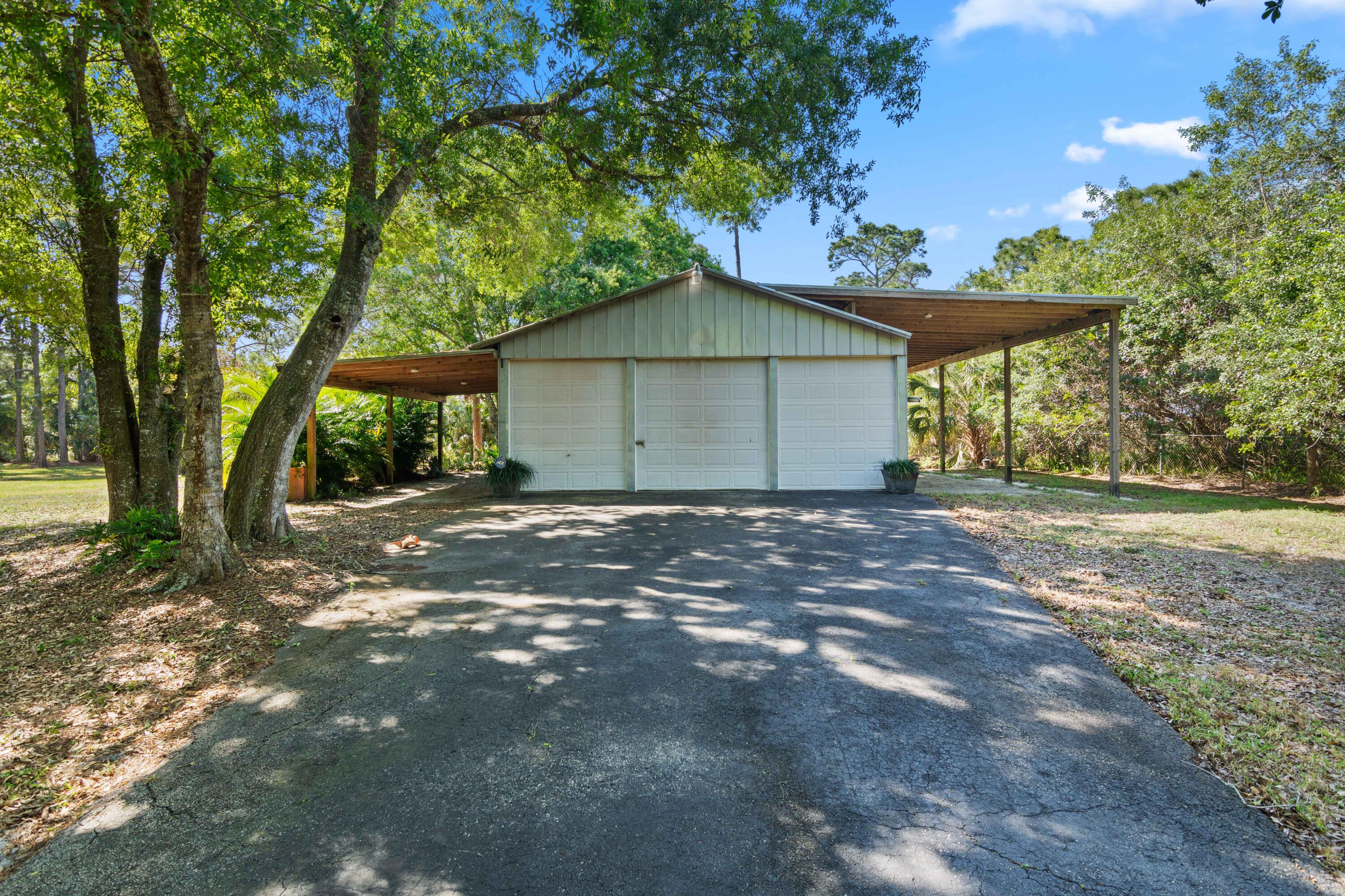 8850 Hidden Pines Road Fort Pierce, FL 34945 - Photo 51 of 72 a house with a tree in front of it
