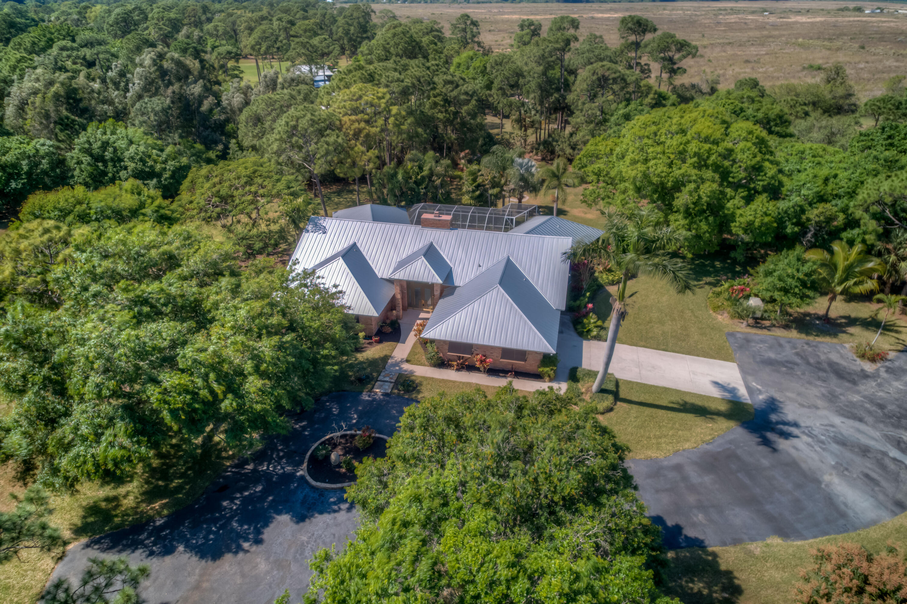 8850 Hidden Pines Road Fort Pierce, FL 34945 - Photo 61 of 72 an aerial view of a house with a yard