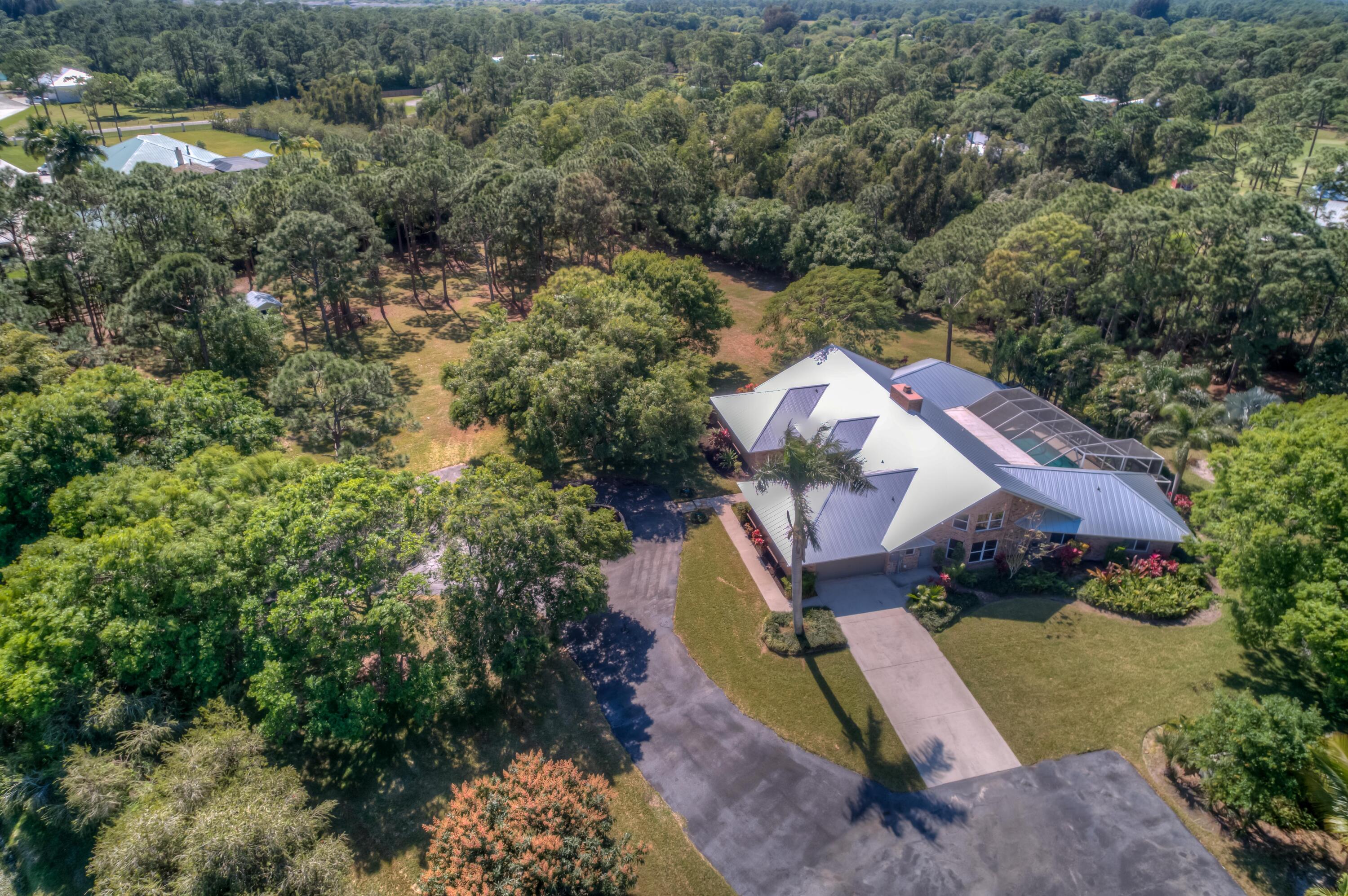 8850 Hidden Pines Road Fort Pierce, FL 34945 - Photo 62 of 72 an aerial view of a house with a garden