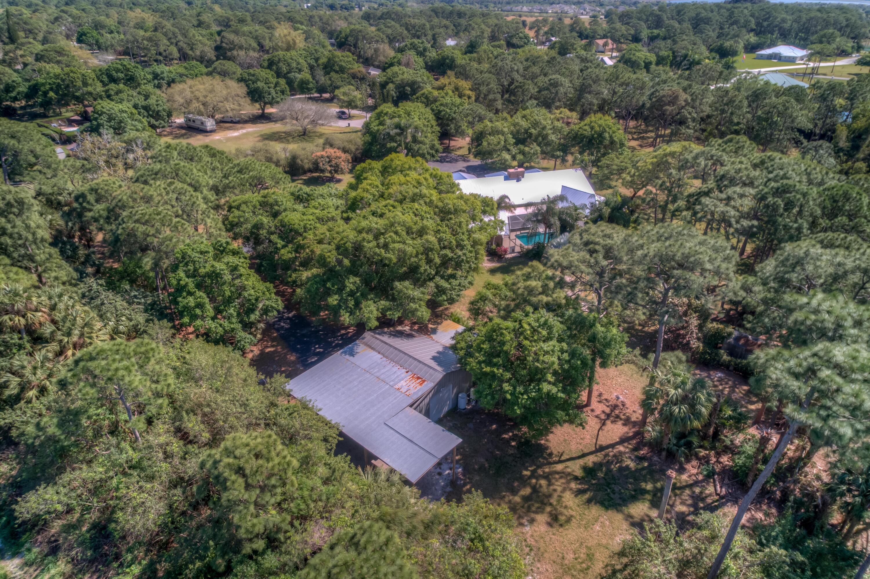 8850 Hidden Pines Road Fort Pierce, FL 34945 - Photo 63 of 72 an aerial view of a house with a yard
