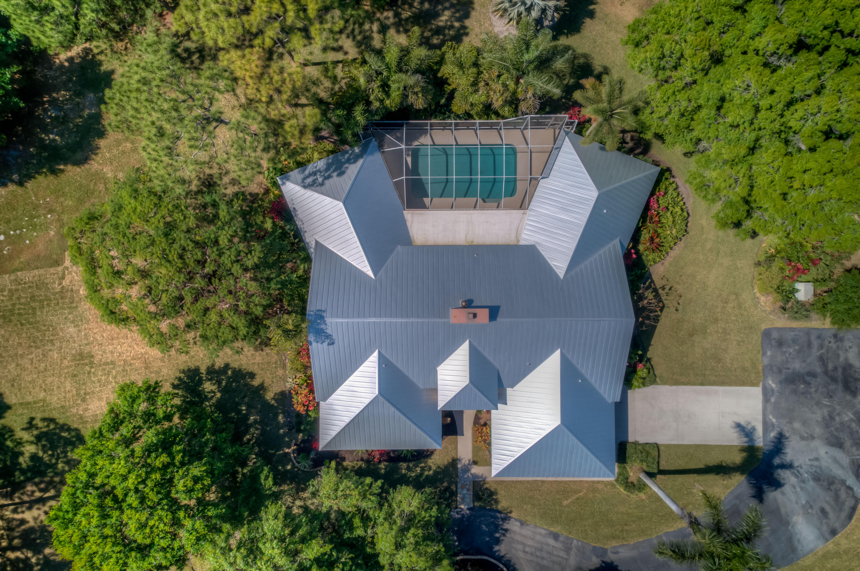 8850 Hidden Pines Road Fort Pierce, FL 34945 - Photo 64 of 72 an aerial view of a house with swimming pool and garden