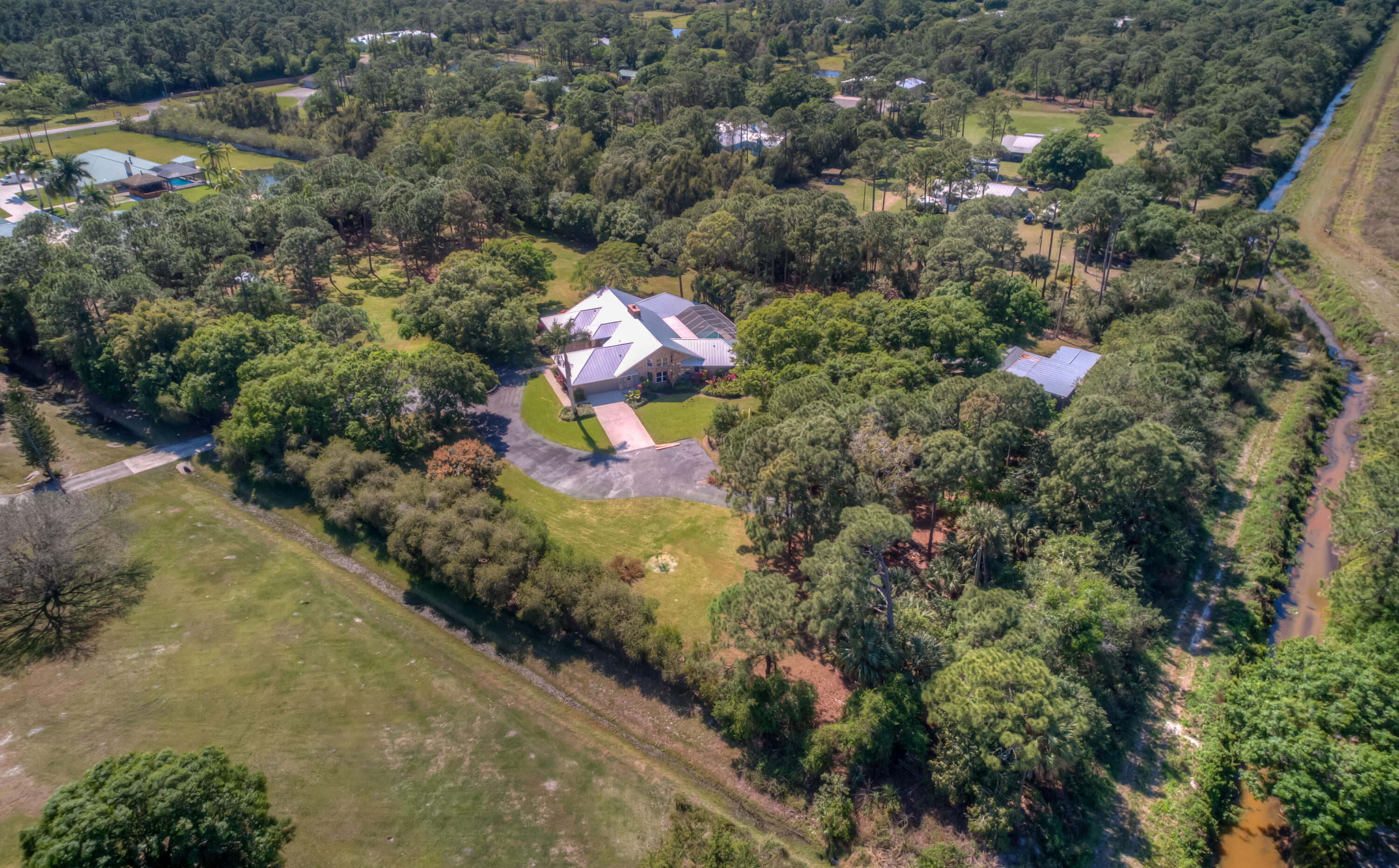 8850 Hidden Pines Road Fort Pierce, FL 34945 - Photo 67 of 72 an aerial view of a house with a yard