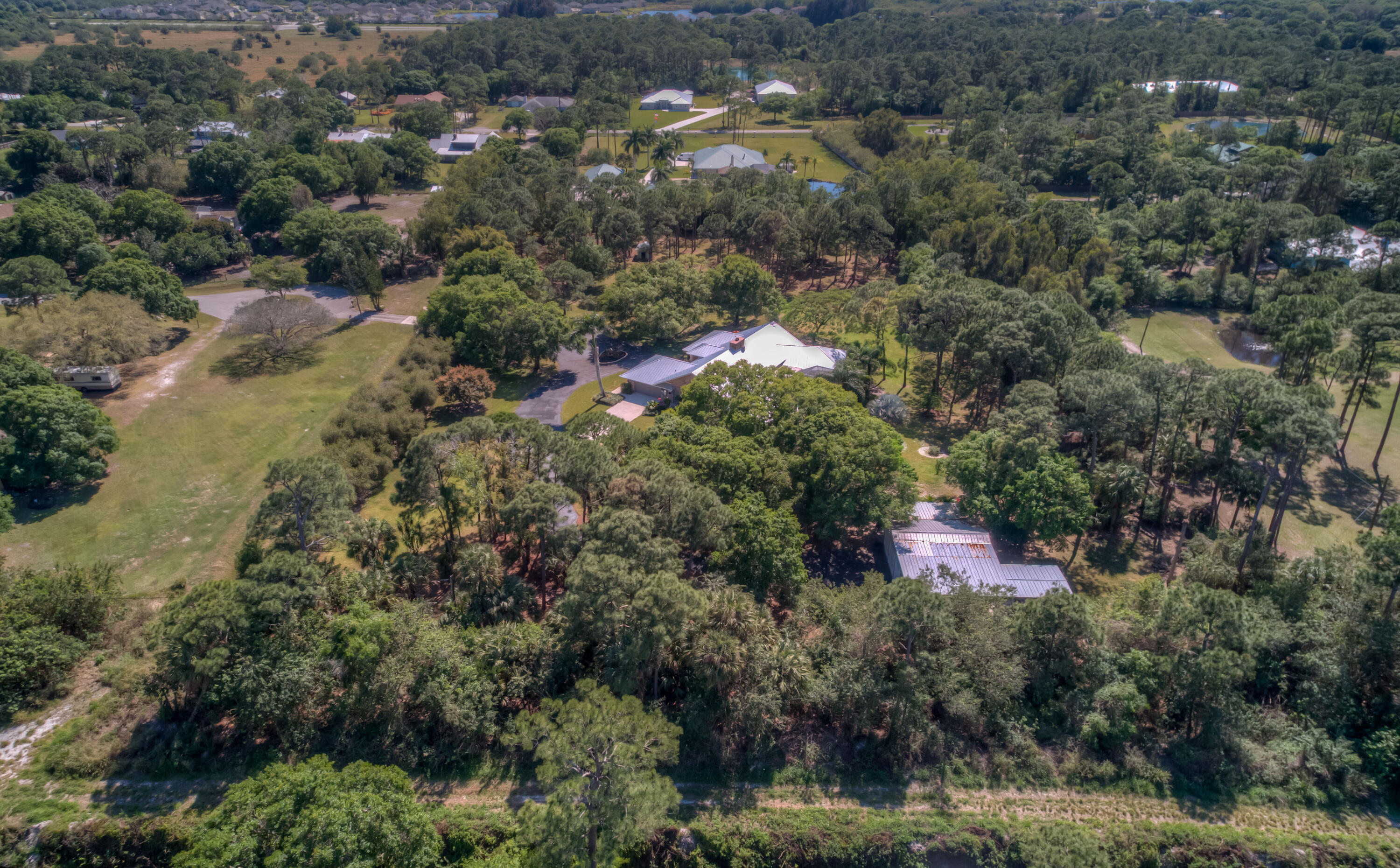 8850 Hidden Pines Road Fort Pierce, FL 34945 - Photo 68 of 72 an aerial view of residential house with outdoor space and trees all around