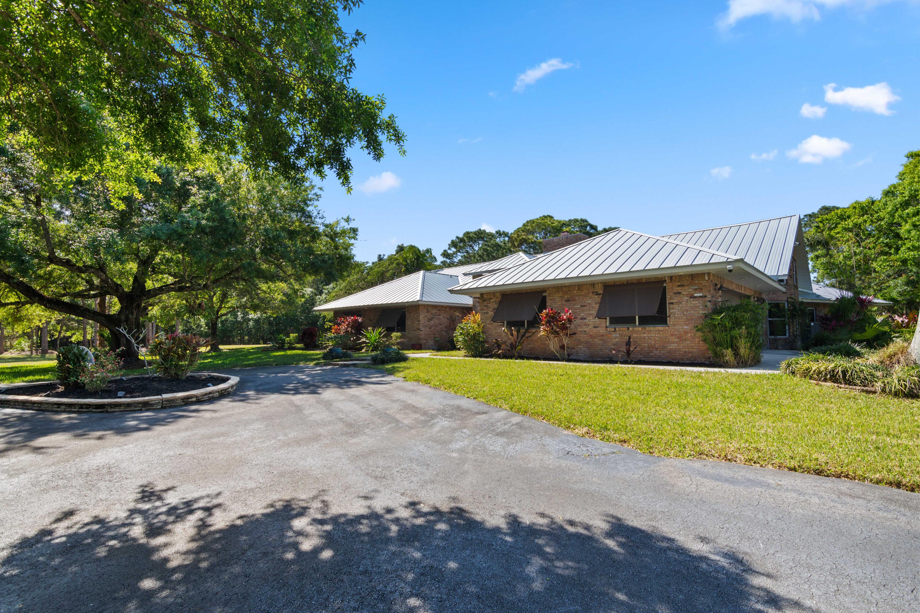 8850 Hidden Pines Road Fort Pierce, FL 34945 - Photo 7 of 72 a front view of house with yard and trees