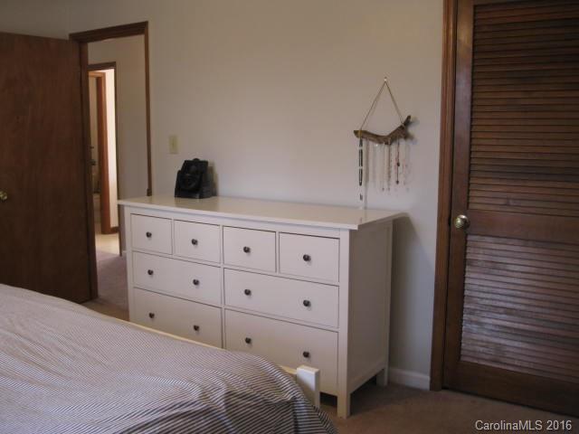 1202 Zeb Helms Road, Unit 4 Monroe, NC 28112 - Photo 14 of 23 a bedroom with a bed and a cabinets