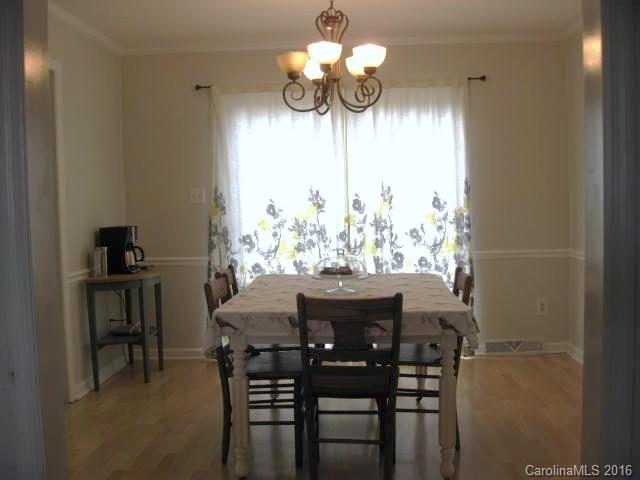 1202 Zeb Helms Road, Unit 4 Monroe, NC 28112 - Photo 8 of 23 a view of a dining room with furniture and chandelier