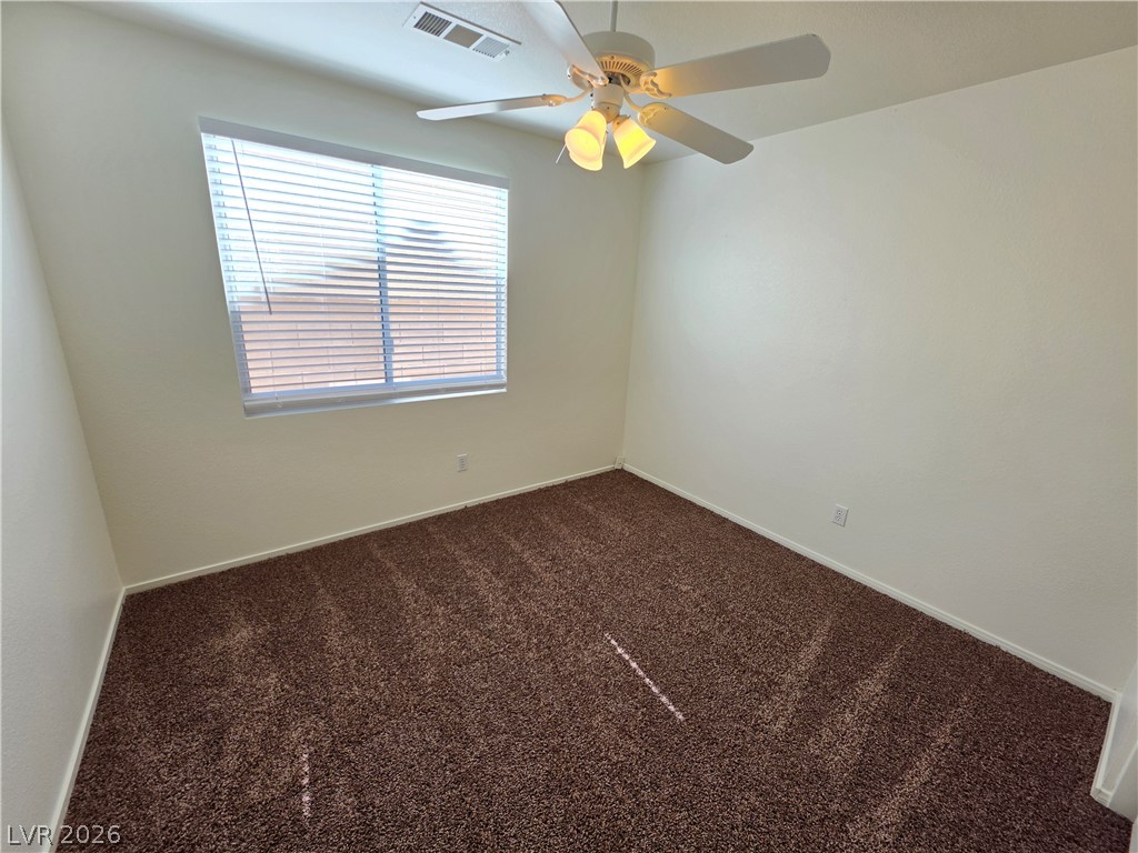 1154 Point Success Avenue Henderson, NV 89014 - Photo 15 of 26 A cozy bedroom with a ceiling fan offers comfort and quiet.
