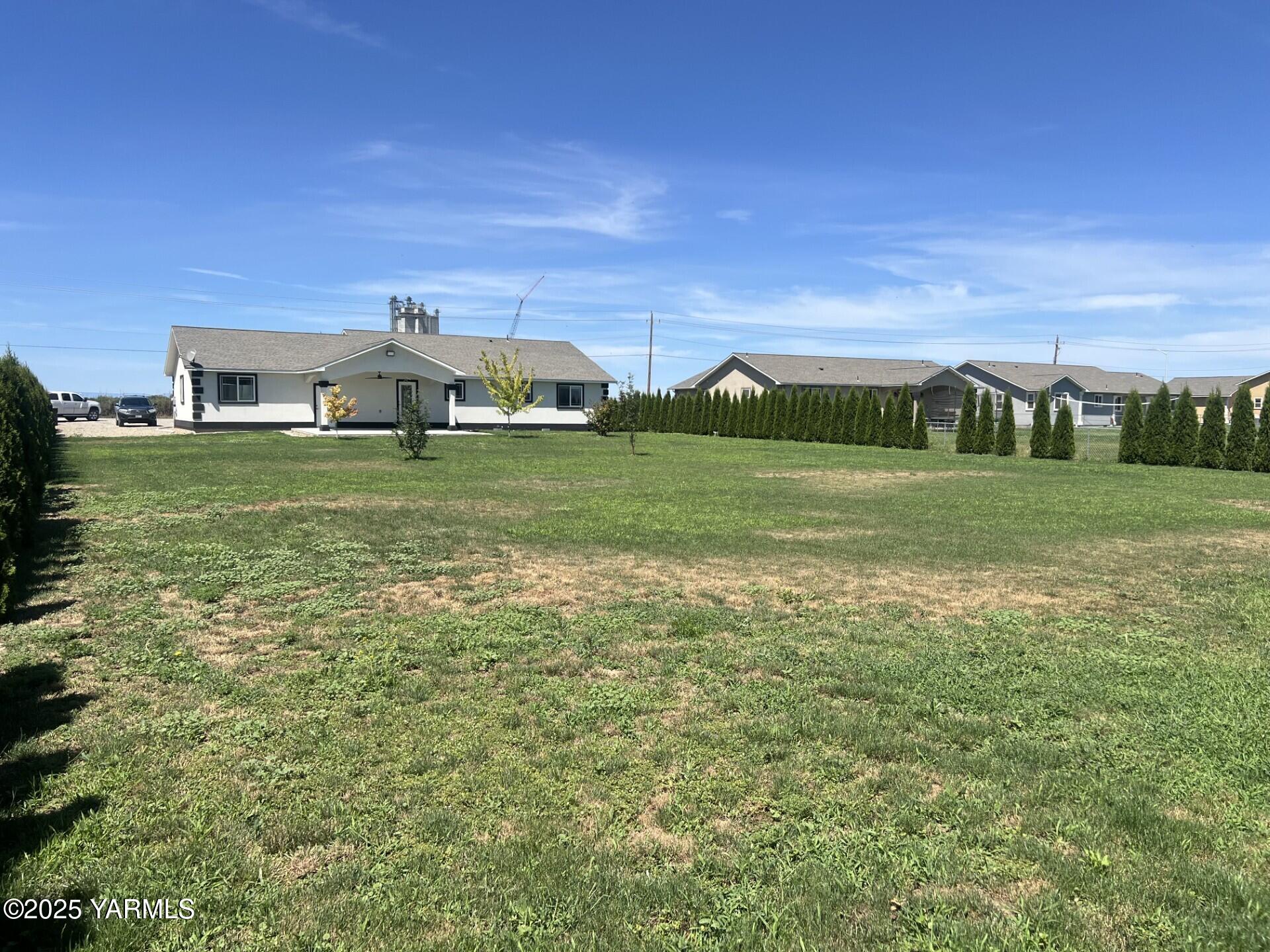 1108 2nd Avenue Granger, WA 98932 - Photo 12 of 13 a view of a big house with a big yard and large trees