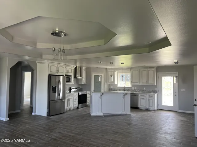 a kitchen with a refrigerator and a stove top oven