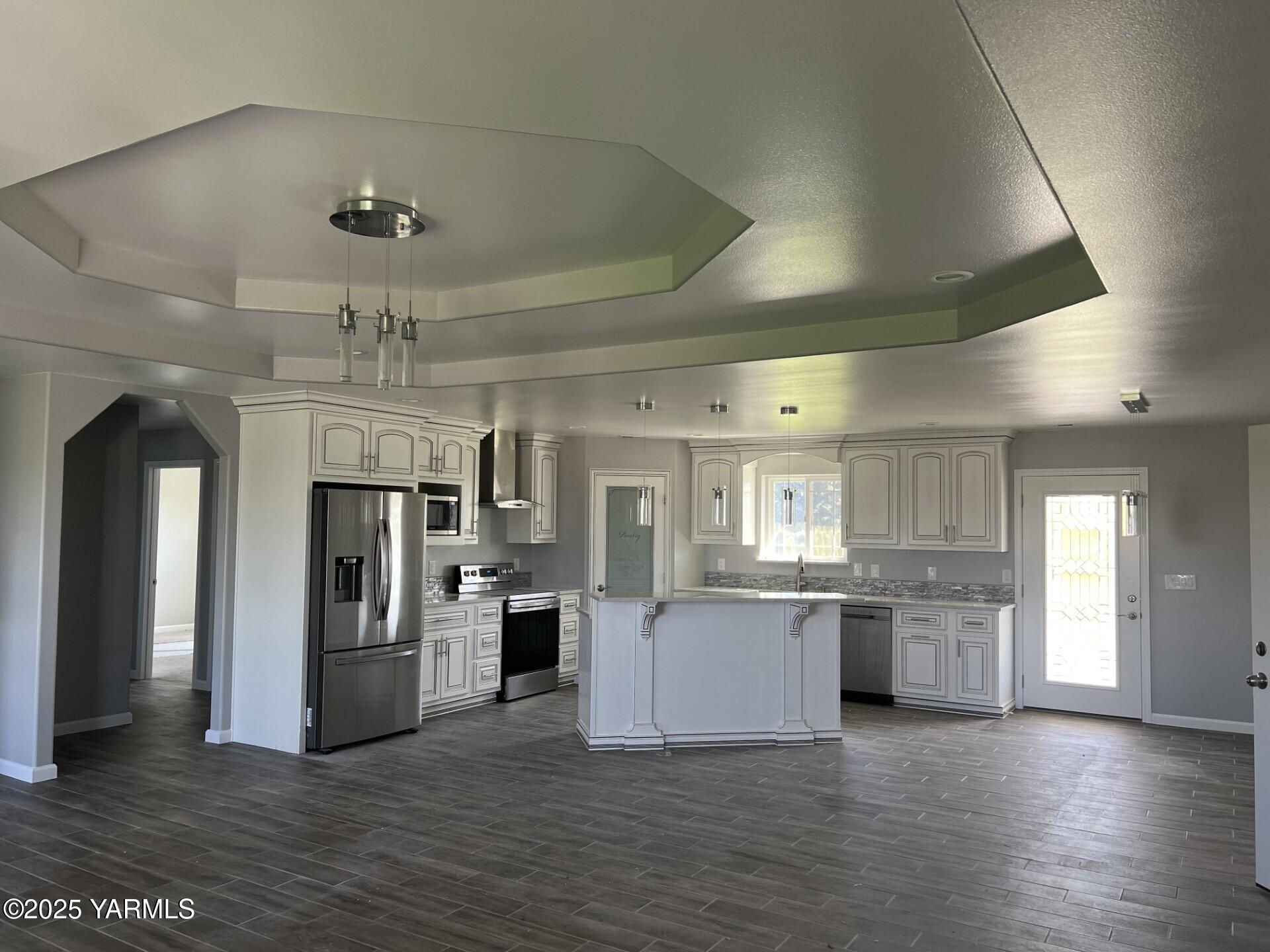 1108 2nd Avenue Granger, WA 98932 - Photo 2 of 13 a kitchen with a refrigerator and a stove top oven