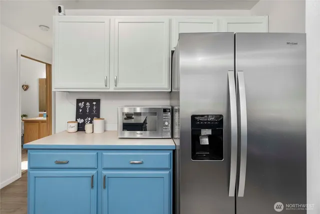 a kitchen with a refrigerator and cabinets