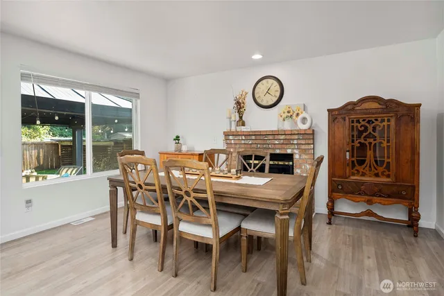 a view of a dining room with furniture window and wooden floor