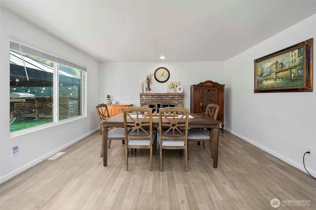 a view of a dining room with furniture window and wooden floor