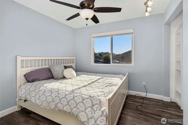 a bedroom with a large bed and a window