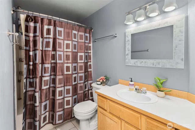a bathroom with a sink vanity mirror and toilet