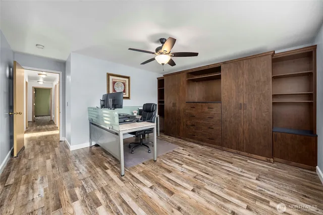 a workspace with wooden floor and windows