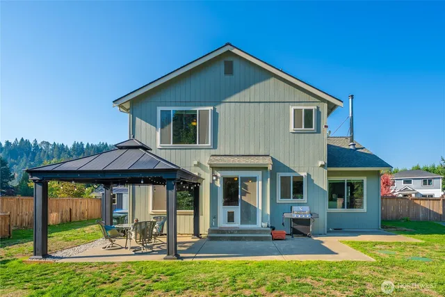 a front view of a house with a yard table and chairs
