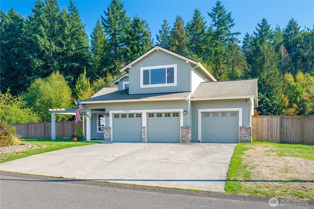 a front view of a house with a garden and garage