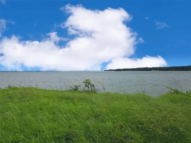a view of a lake with houses in back